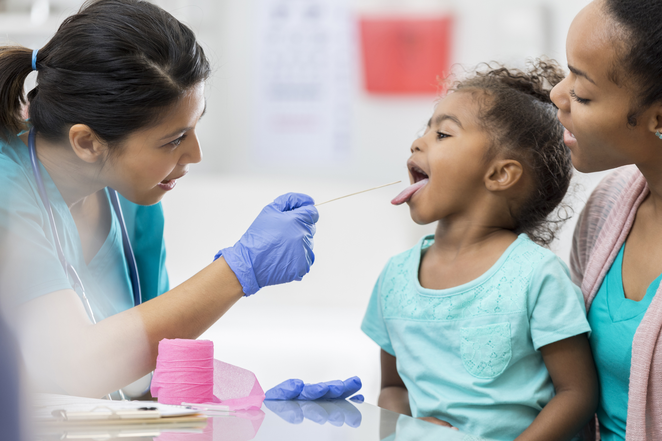 Doctor examines young African American patient Doctor examines young African American patient