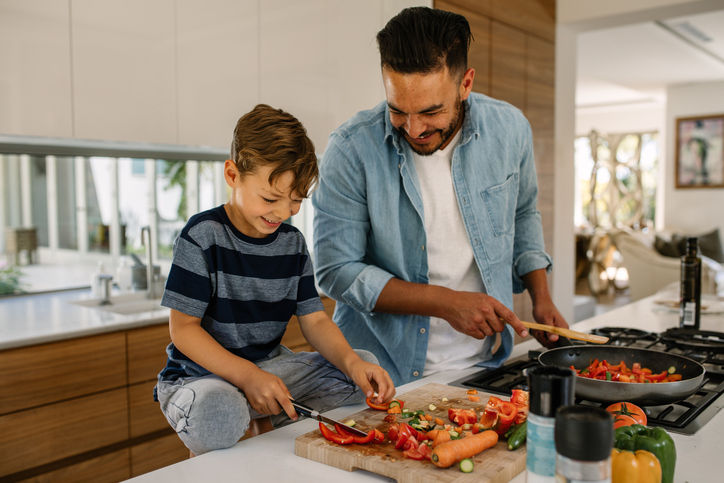 Father and son preparing food in kitchen Father and son preparing food in kitchen