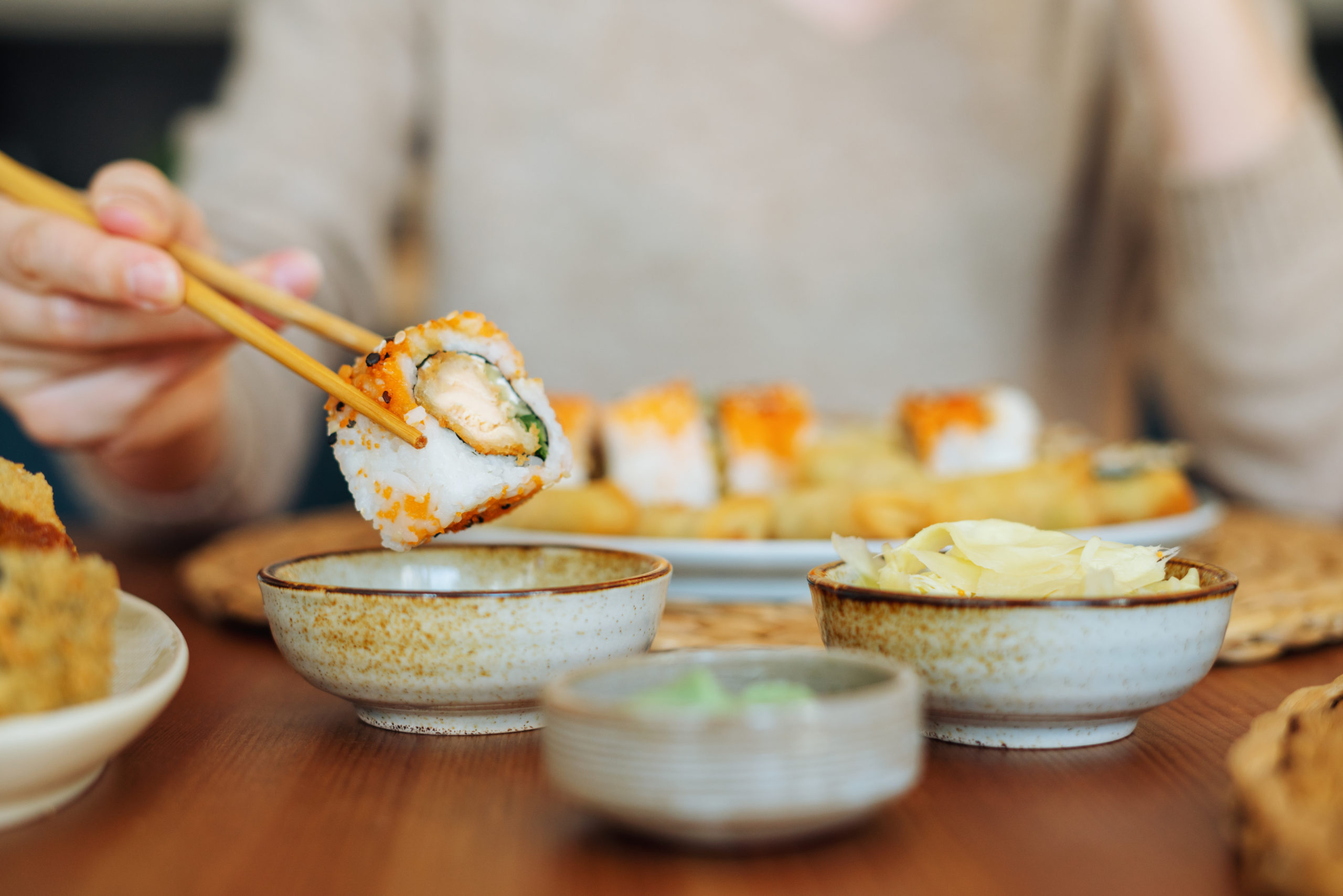 Woman eating sushi rolls