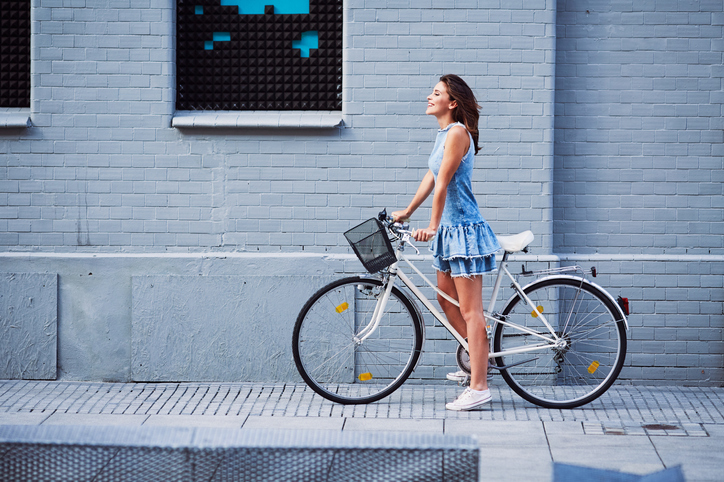 Woman on bike trip in the city during summer